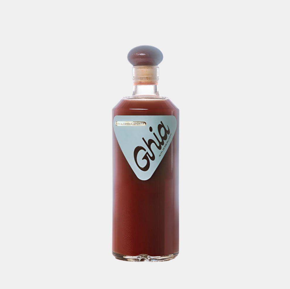 “Ghia Apéritif – non-alcoholic bitter spirit in brown bottle”
“Ghia bottle on bar cart with citrus and glass”
“Botanical alcohol-free apéritif with herbal and citrus notes”
